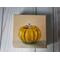 Photo of small square canvas painting of orange pumpkin with peach colored background