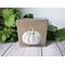 Photo of small square canvas painting of white pumpkin with a light brown background
