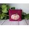 Photo of small square canvas painting of peach colored pumpkin with a raspberry pink background