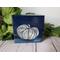 Photo of small square canvas painting of oddly shaped light blue pumpkin with a dark blue background