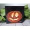 Photo of small square canvas painting of glowing jack o'lantern pumpkin with a black background