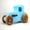 This handmade wooden toy car, modeled after a 1927 Ford T-Coupe, is hand-painted baby blue with black and metallic sapphire blue. The wheels are finished with nonmarring amber shellac.