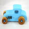 This handmade wooden toy car, modeled after a 1927 Ford T-Coupe, is hand-painted baby blue with black and metallic sapphire blue. The wheels are finished with nonmarring amber shellac.