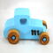 This handmade wooden toy car, modeled after a 1927 Ford T-Coupe, is hand-painted baby blue with black and metallic sapphire blue. The wheels are finished with nonmarring amber shellac.