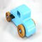 This handmade wooden toy car, modeled after a 1927 Ford T-Coupe, is hand-painted baby blue with black and metallic sapphire blue. The wheels are finished with nonmarring amber shellac.