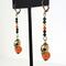 Halloween skull dangle earrings, with orange and black crystals.