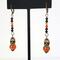 Halloween skull dangle earrings, with black and orange crystals.