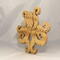 A handcrafted octopus puzzle made from wood. The puzzle is freestanding and can comfortably sit on a shelf, table, window sill, or door frame.