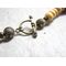 Necklace measures 23 inches long and closes with a brass toggle clasp