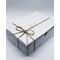 white gift box with string bow tied