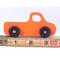 A handmade wooden toy pickup truck painted Pumpkin Orange and Black from my Play Pal Collection