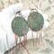 Paisley-impressed 2-inch copper disc Chandelier Boho Earrings Emerald green and antiqued Patina, Melted Twists of Copper Dangles, Argentium 935 Sterling Silver Ear Wires photo of earring in gloved hand to show size