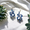 Blue and Silver Resin snake earrings. Completed with silver finish hypoallergenic ear wires.