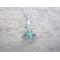aqua and green sea glass framed silver charm accented with a clear crystal decorated bail hung on  sterlings silver chain.
