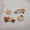 4 little flqt wooden magnets. A maple leaf shape that is a beige wood color with dark green painted veins, a pumpkin of the same color with painted curved lines and a painted green leaf on the front. 2 old fashioned style trucks that have pumpkins in the back. Both a slightly different shape, but both are a beige wood color, with some white and maroon on them.