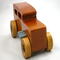 This handmade wooden toy car is based on a 1932 Ford Sedan Hot Rod. It is hand-finished with multiple coats of amber shellac and trimmed with black and grey acrylic paint.