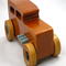 This handmade wooden toy car is based on a 1932 Ford Sedan Hot Rod. It is hand-finished with multiple coats of amber shellac and trimmed with black and grey acrylic paint.
