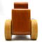 This handmade wooden toy car is based on a 1932 Ford Sedan Hot Rod. It is hand-finished with multiple coats of amber shellac and trimmed with black and grey acrylic paint.