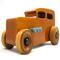 This handmade wooden toy car is based on a 1932 Ford Sedan Hot Rod. It is hand-finished with multiple coats of amber shellac and trimmed with black and grey acrylic paint.