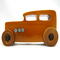 This handmade wooden toy car is based on a 1932 Ford Sedan Hot Rod. It is hand-finished with multiple coats of amber shellac and trimmed with black and grey acrylic paint.