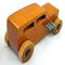 This handmade wooden toy car is based on a 1932 Ford Sedan Hot Rod. It is hand-finished with multiple coats of amber shellac and trimmed with black and grey acrylic paint.
