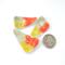 photo showing three abstract triangle copper enamel buttons with yellow, orange, and olive green torch fired enamel on copper - shown with quarter for size relationship