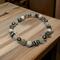 White lava rock and glass beads on a stretch cord.