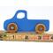 unHandmade wooden toy pickup truck painted in baby blue with metallic sapphire blue trim. The truck features non-marring amber shellac wheels and is part of my Play Pal Collection. A close-up shot of the toy truck on a white background. Made to Order.defined