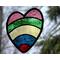 Large stained glass heart with 5 color arcs: red, blue, yellow, green and rose with nature background