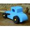 A wooden toy car modeled after a 27 T-Coupe is handcrafted and painted with baby blue, black, and metallic gold acrylic paint.