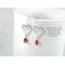 Silver heart earrings with bezel set orange citrine gemstones.