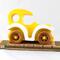 Handmade wooden toy car painted bright yellow with white fenders and non-marring amber shellac-finished spoked wheels, modeled after the classic Model-T Sedan.