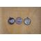 Cat and dog round silver photo charms next to a dime to show size comparison.