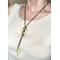 Peridot jasper donut pendant and teardrop tassels with bronze SilverSilk knitted wire chain.