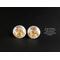 Prong-set golden citrine stud earrings with sterling silver disc jackets. The jackets are embossed with a floral pattern.