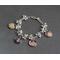 Silver bracelet with decorative balls featuring four personalized photo charms of children. 