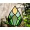 Spring Awakens Stained Glass Drop, featuring 12 pieces of hand-cut glass in spring greens and yellow, with plants & window in the background