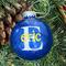 Blue Christmas Round 3" Ornament with a single white initial in the center with a name decal layered on top in yellow.  