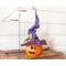 This image shows the size of Violet the Halloween witch. She is 13 inches tall and 4 inches wide. She is sitting on a vintage trunk. 