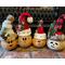 Here is a group of handmade Christmas gourds. Each elf has a custom hat and a cute elf facial expression carved out of their gourd shell.