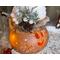 This image shows the candlelight shining through Tinsel's face and decorative snowflakes carved into the gourd shell. 