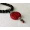 Black beaded necklace with red pendant