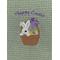 Bunny and colored eggs  in basket on green mist towel