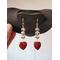 Light Gray Beaded Dangle Earrings with Red Banded Heart Charm dangles on a jewelry display.  The red bands are darker than the charm.