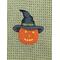 Pumpkin with Black hat on Olive colored towel