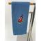 Blue towel with golf bag and golfing items