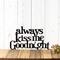 Always Kiss Me Goodnight metal wall art, in matte black powder coat. Placed against a white wood wall.