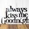 Always Kiss me Goodnight metal wall decor, in raw steel. Placed against a wood wall.