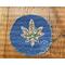 Blue denim patch with fall print fabric hemp leaf with green stitching in the center.
