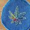 green stitched hemp leaf on blue denim round patch.